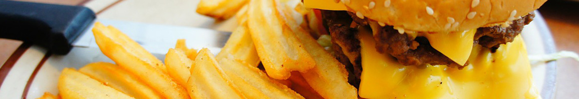 Eating Burger at Red's Burgers restaurant in Seward, AK.